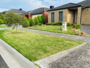 Suburban house with manicured lawn and garden.